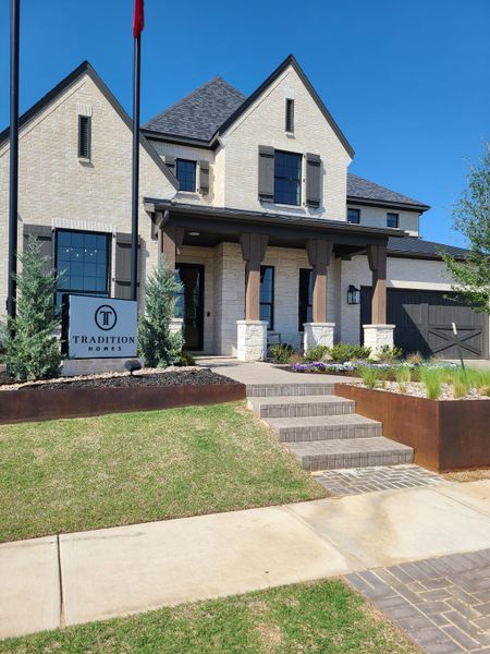 An elegant stone home with modern accents and lush landscaping in Lakewood at Brookhollow – 60′ by Tradition Homes (Prosper, TX). An elegant stone home with modern accents and lush landscaping in Lakewood at Brookhollow – 60′ by Tradition Homes (Prosper, TX).
