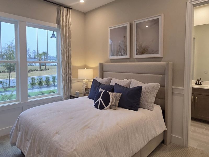 A cozy bedroom featuring a plush bed, elegant curtains, and soft lighting for a tranquil atmosphere.