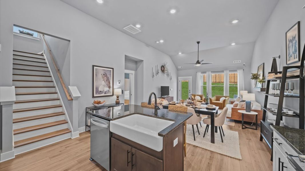 Kitchen with large island with quartz countertops, white cabinetry, Whirpool appliances at Aspen Ridge by DRB Homes in Lyman Kitchen with large island with quartz countertops, white cabinetry, Whirpool appliances at Aspen Ridge by DRB Homes in Lyman