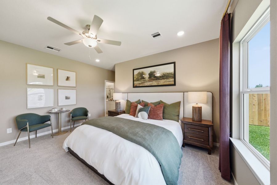 A bedroom with a bed and a fan. A bedroom with a bed and a fan.