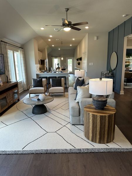 An inviting living space with modern decor, cozy seating, and an open layout leading to the kitchen. An inviting living space with modern decor, cozy seating, and an open layout leading to the kitchen.
