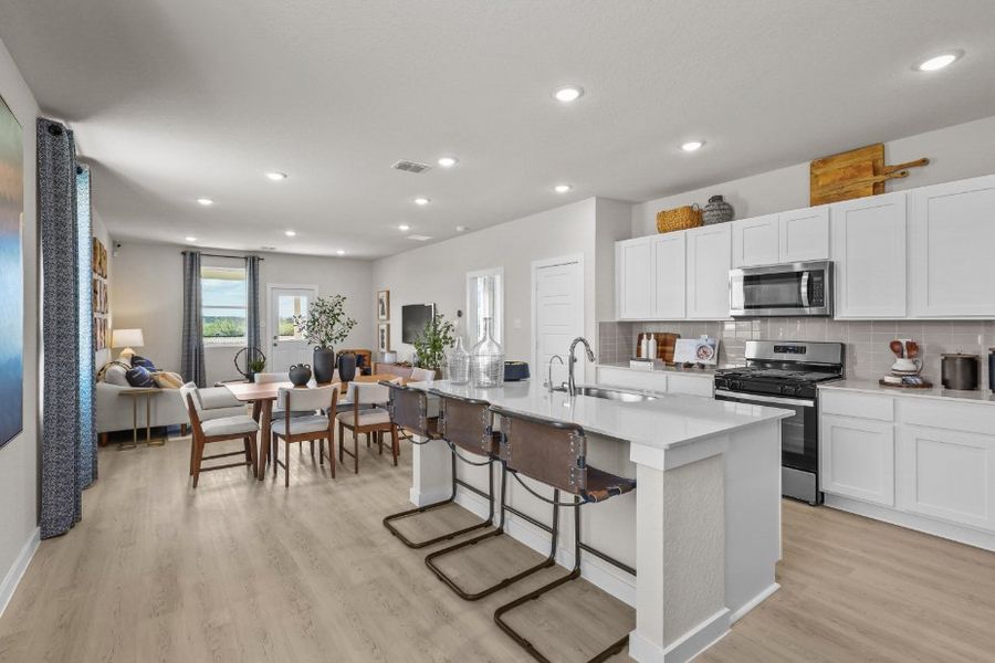A kitchen with white cabinets.