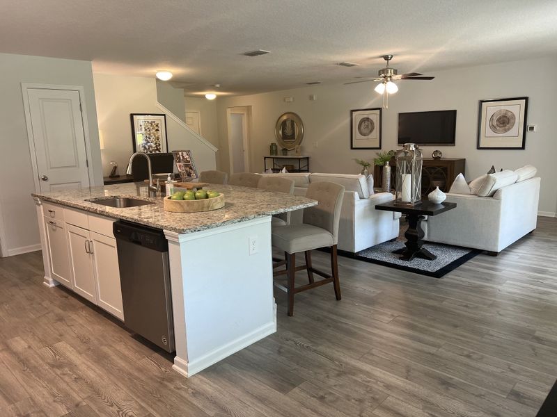 An open-concept living space featuring a granite island, cozy seating, and elegant decor with modern accents. An open-concept living space featuring a granite island, cozy seating, and elegant decor with modern accents.