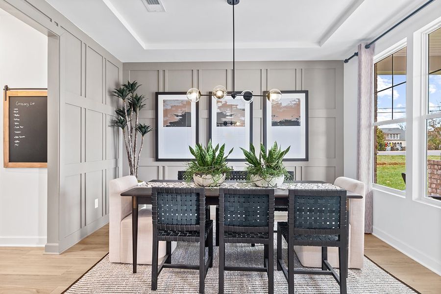 A dining room with a large table and chairs. A dining room with a large table and chairs.