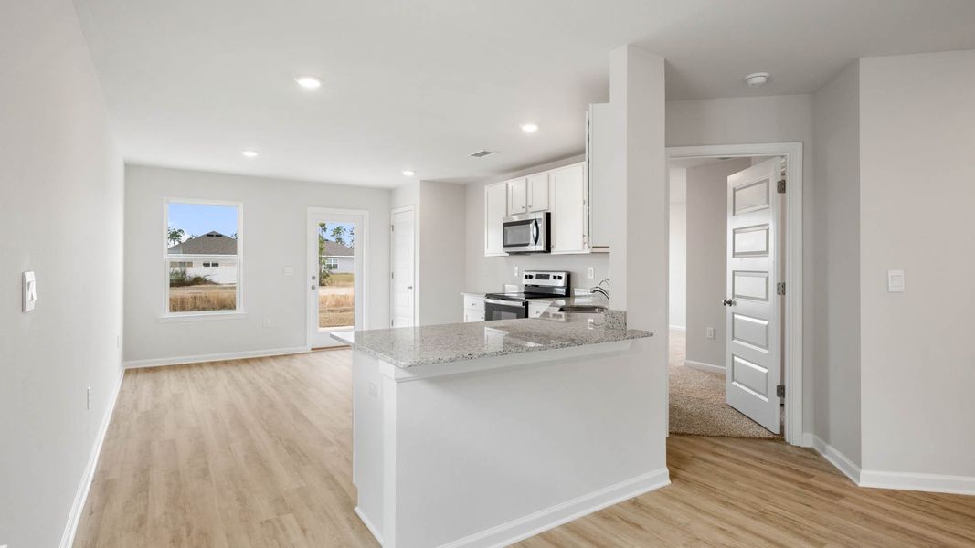 Furnished interior in a model home at Chateau Nemours in Port Saint Joe (Image 8).