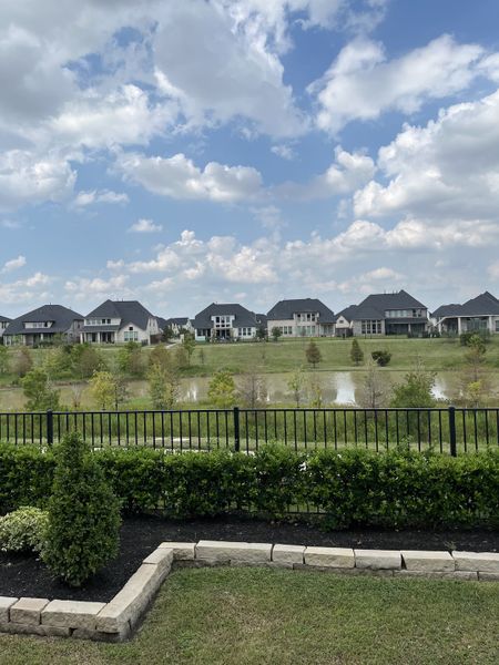 A picturesque lake view with elegant homes in Cross Creek West 45' by Perry Homes, Fulshear, TX.