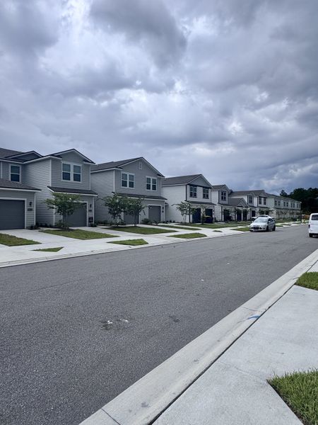 Modern two-story homes line the street in The Villas at Bishop Oaks by Century Communities, Jacksonville, FL.