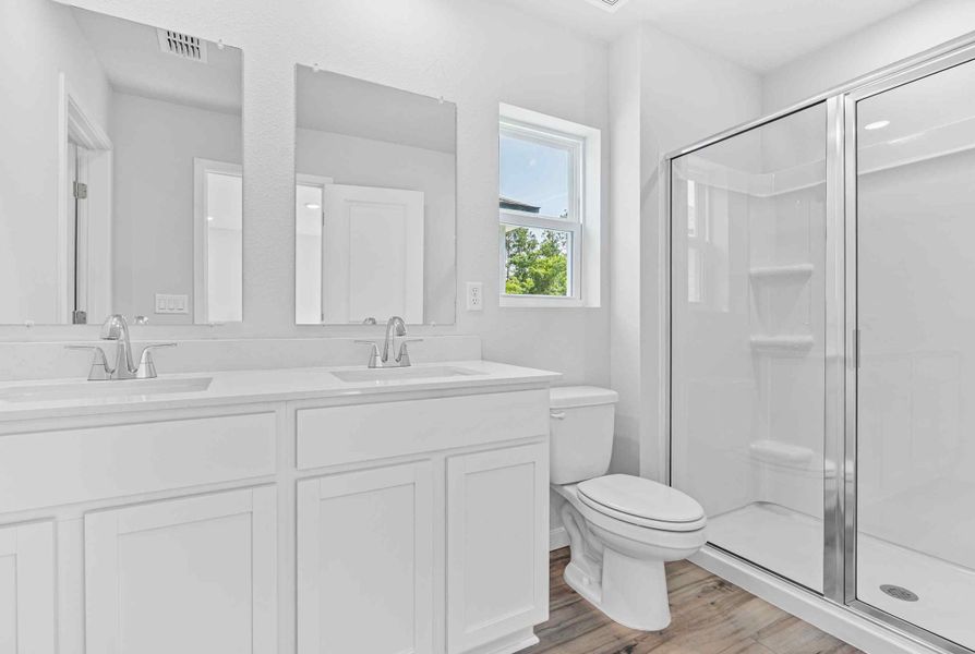 Davor Paired Home Primary Bath with Shower and Dual Vanities at The Landings at Pecan Park in Jacksonville