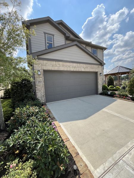 A modern two-story home with a manicured garden in Bauer Meadows by KB Home (Hockley, TX).