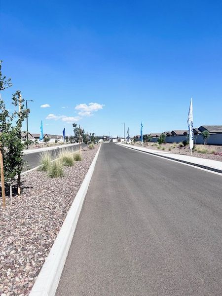 A scenic community entrance at Bella Vista Trails Estate Series by Meritage Homes in San Tan Valley, AZ, with landscaped pathways. A scenic community entrance at Bella Vista Trails Estate Series by Meritage Homes in San Tan Valley, AZ, with landscaped pathways.