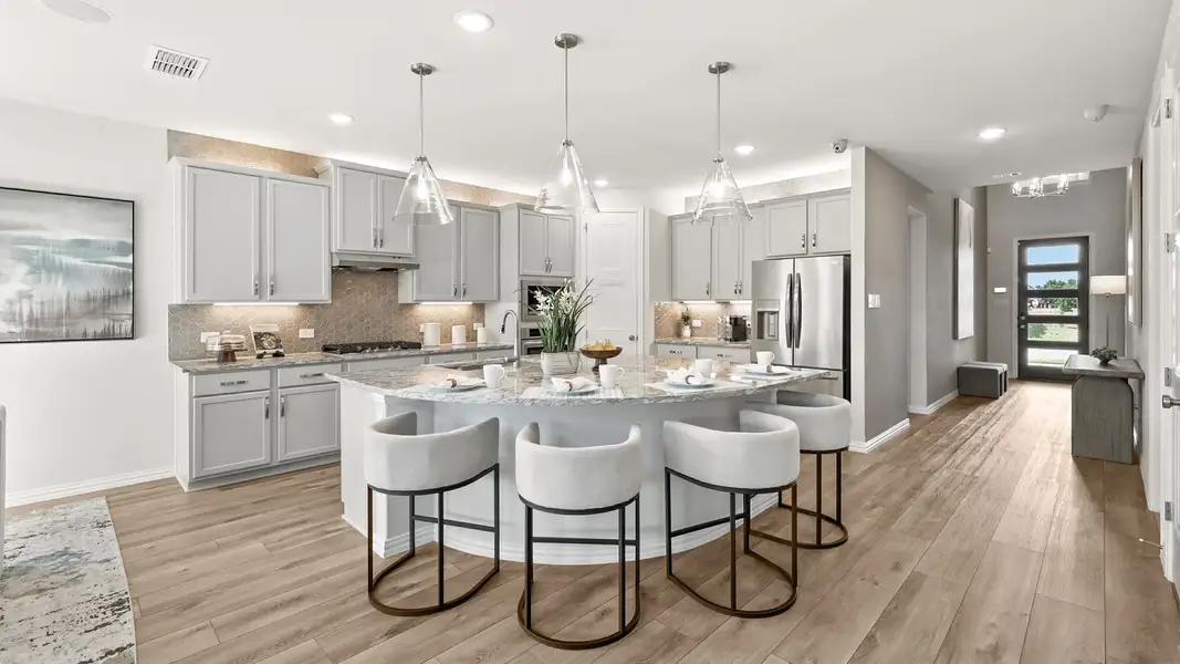 Bright open-concept kitchen with oversized island, pendant lighting, and elegant finishes throughout. Bright open-concept kitchen with oversized island, pendant lighting, and elegant finishes throughout.