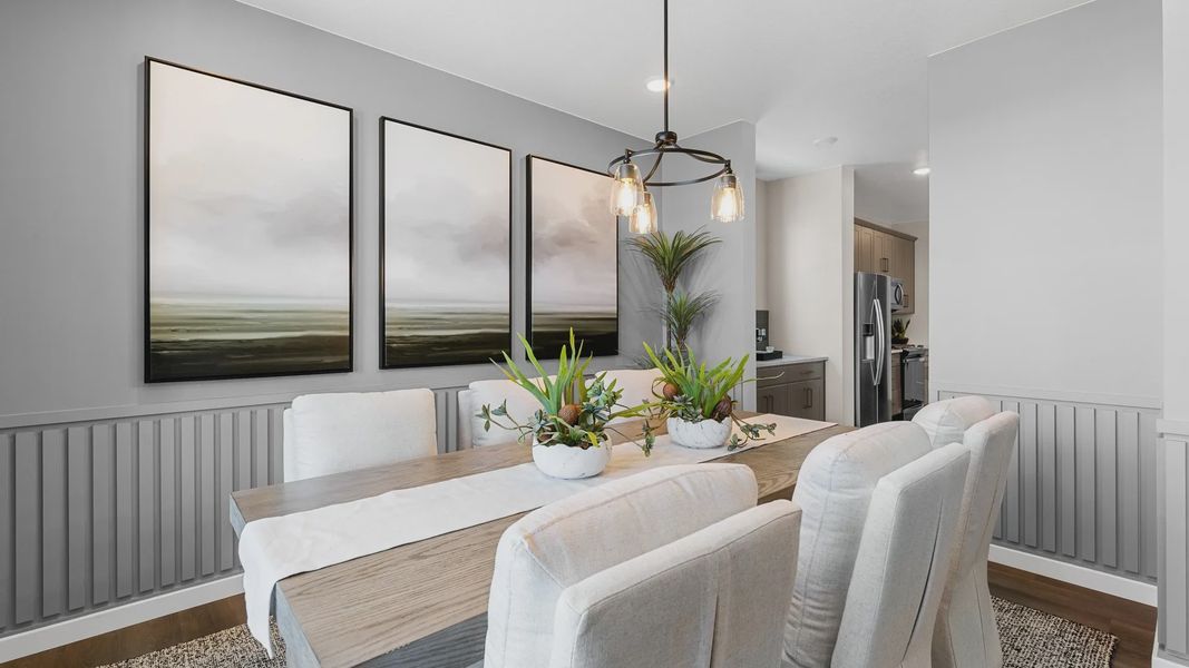 Experience luxury in Timnath Lakes' dining room, featuring abstract art, refined cabinetry, and elegant chandelier design. Experience luxury in Timnath Lakes' dining room, featuring abstract art, refined cabinetry, and elegant chandelier design.