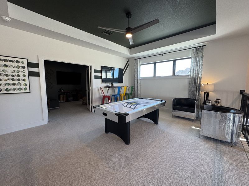 A vibrant game room with air hockey table, colorful seating, and stylish decor. Perfect for entertainment and relaxation.