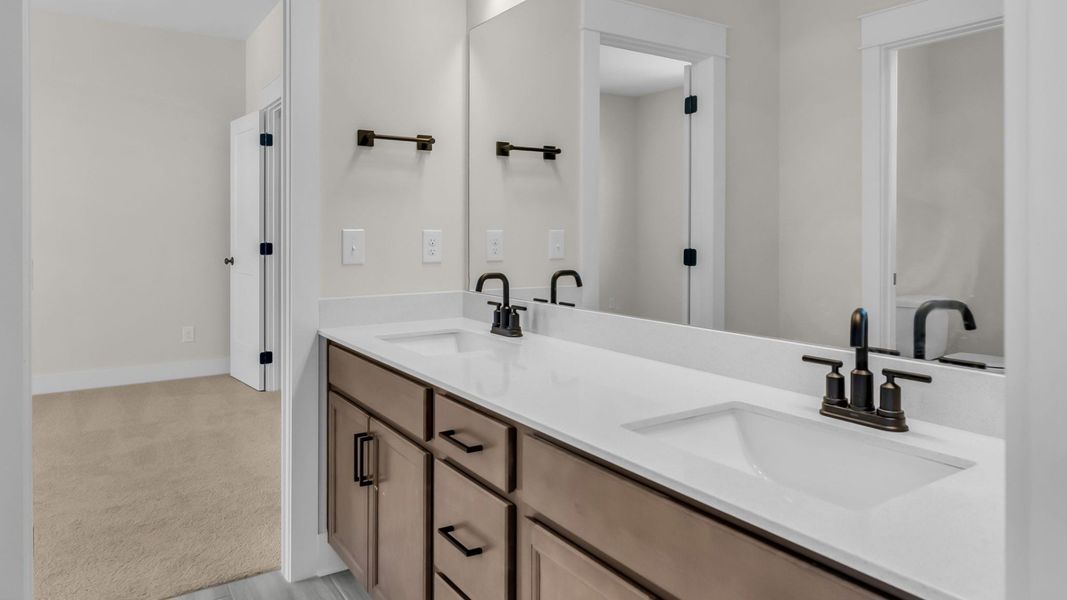 Bathroom with dual vanity and designated area for toilet Bathroom with dual vanity and designated area for toilet