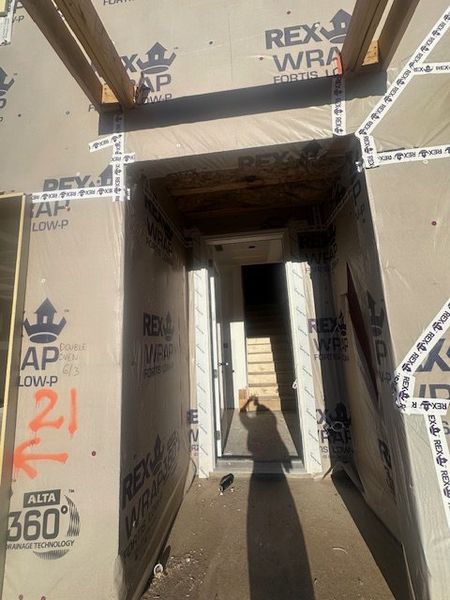 A new home under construction in Echo Park by UnionMain Homes (Suwanee, GA) with a partially completed entrance and stairs.