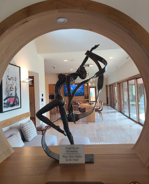 A modern interior with an elegant sculpture, open layout, and stylish wooden accents. A modern interior with an elegant sculpture, open layout, and stylish wooden accents.