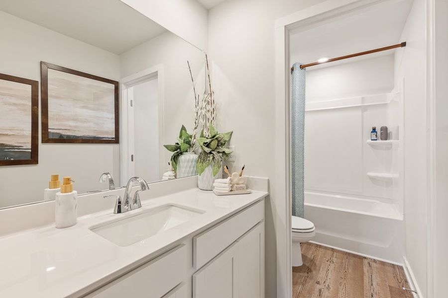 A bathroom with a sink and a toilet. A bathroom with a sink and a toilet.