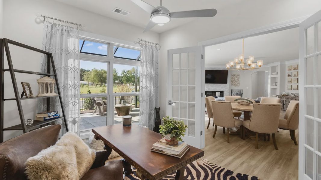 Furnished interior in a model home at Courtyards by Carrell in Ocean Isle Beach (Image 17).