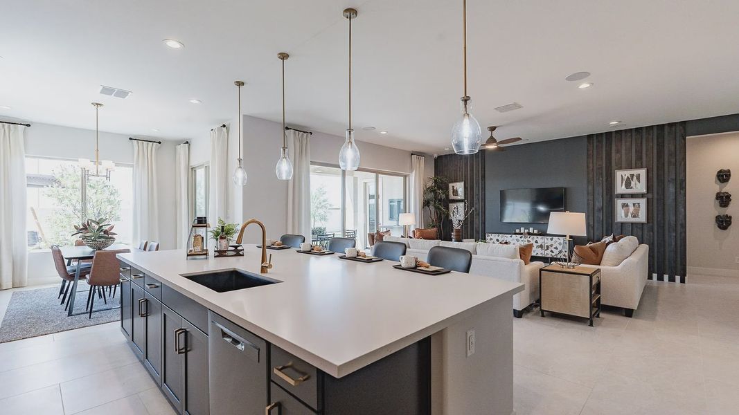 Exquisite kitchen features large island, sleek pendant lights, and chic dining in Windrose.