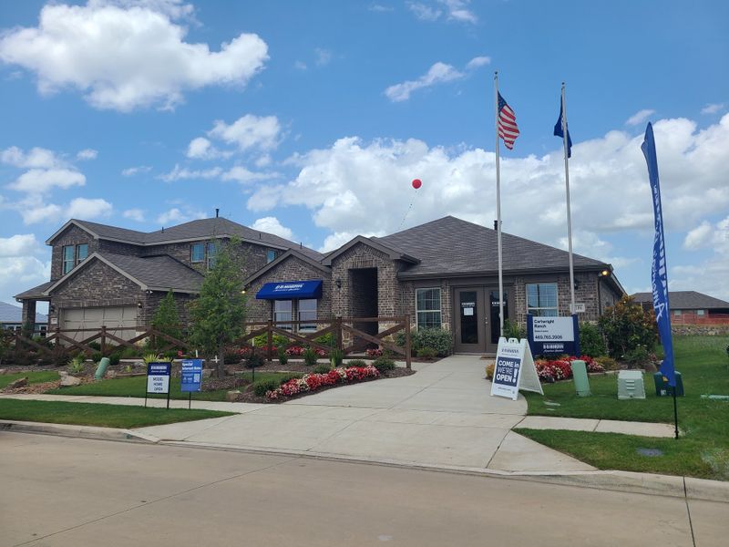A charming brick home with vibrant landscaping in Cartwright Mays by D.R. Horton, set against a clear blue sky in Crandall, TX. A charming brick home with vibrant landscaping in Cartwright Mays by D.R. Horton, set against a clear blue sky in Crandall, TX.
