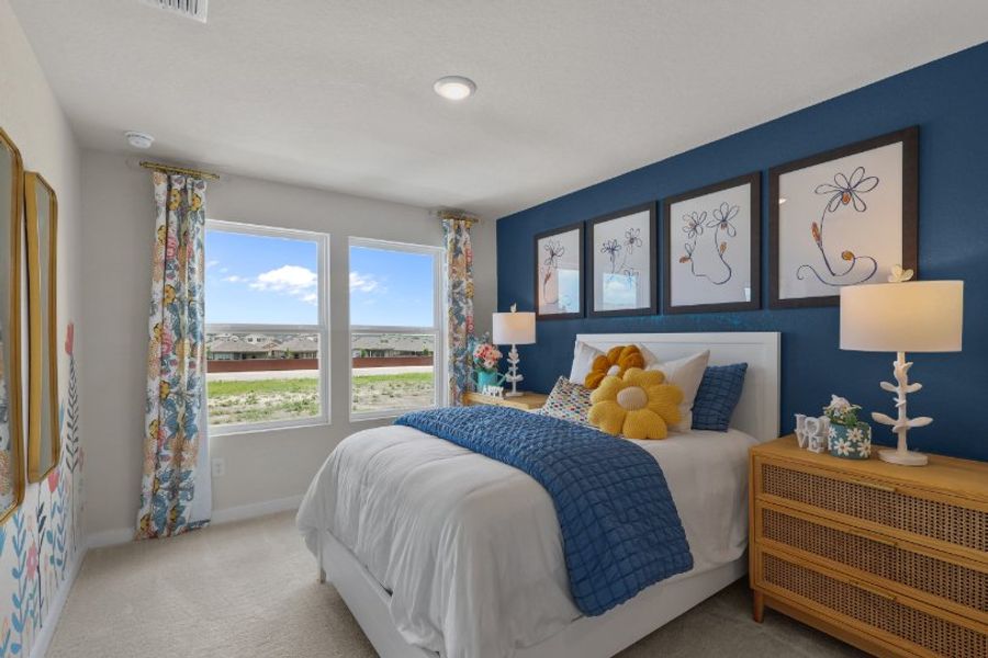 A bedroom with a large window.