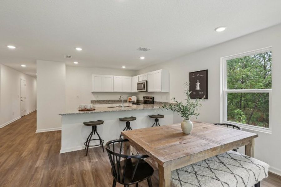 A kitchen with a table and chairs. A kitchen with a table and chairs.
