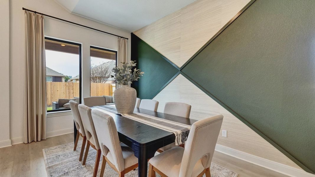 This elegant dining space features high ceilings, abundant natural light, and a accent wall that creates the perfect backdrop This elegant dining space features high ceilings, abundant natural light, and a accent wall that creates the perfect backdrop