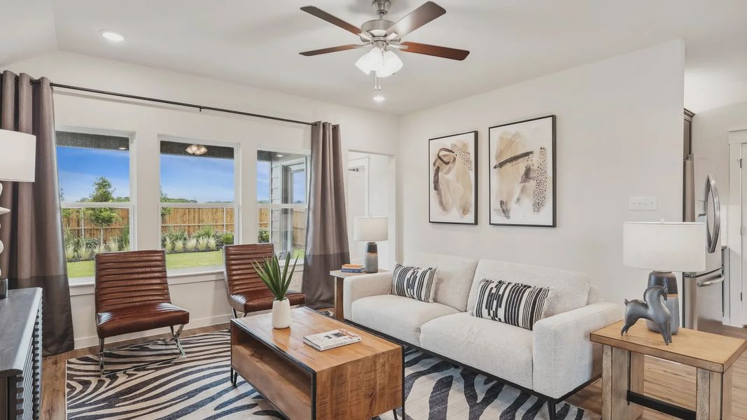 Elegant zebra rug, abstract art, and wood accents enrich this Simpson Crossing living room.