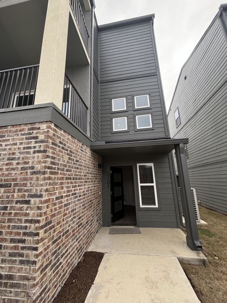 A modern gray and brick facade at Ira Ave Lofts by Center City, San Antonio, TX, featuring sleek design elements. A modern gray and brick facade at Ira Ave Lofts by Center City, San Antonio, TX, featuring sleek design elements.