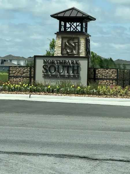 Welcome to Northpark South by Century Communities in Porter, TX—an inviting entrance with landscaping and a stylish sign.