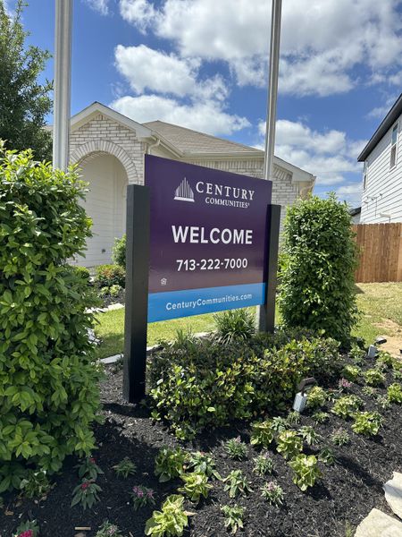 A welcoming entrance sign surrounded by lush landscaping at Willow Trace 45' by Century Communities (Spring, TX).