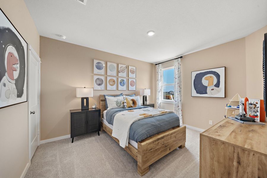 A bedroom with a bed and a bench.