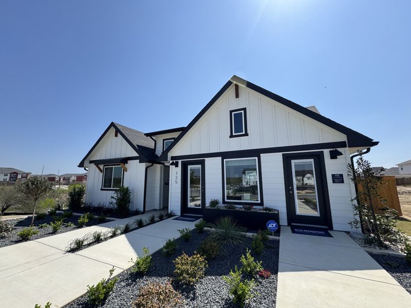 A charming white modern farmhouse with a landscaped front in Trace by D.R. Horton (San Marcos, TX). A charming white modern farmhouse with a landscaped front in Trace by D.R. Horton (San Marcos, TX).