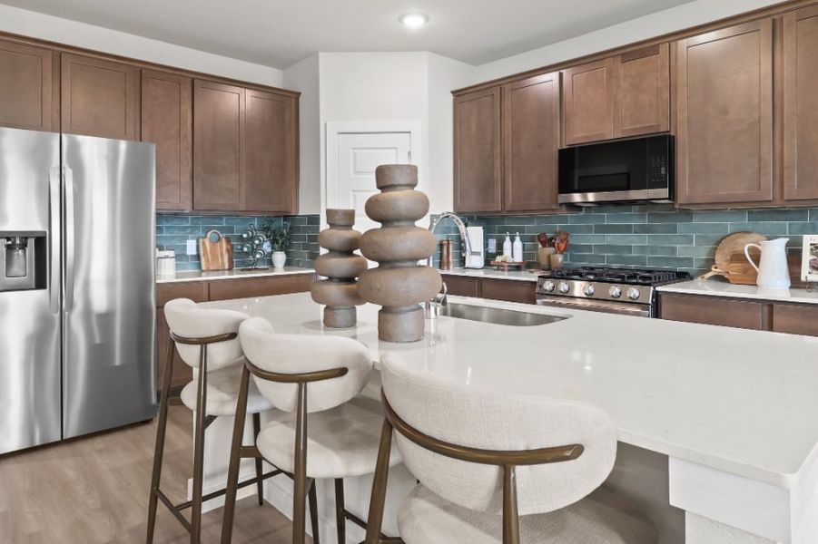A kitchen with a table and chairs. A kitchen with a table and chairs.
