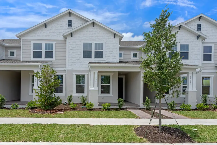 Front exterior of a home in the Harvest at Ovation - Townhomes community, located in Winter Garden, FL (Image 32).