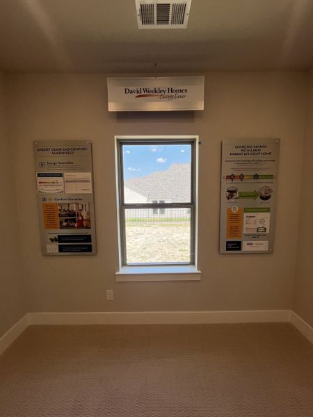 A well-lit room featuring an Energy Saver display, highlighting sustainability features by David Weekley Homes. A well-lit room featuring an Energy Saver display, highlighting sustainability features by David Weekley Homes.