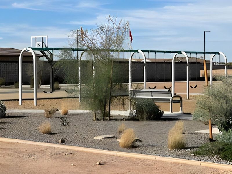 A scenic playground with swings and desert landscaping in The Ridge Collection at North Copper Canyon by Century Communities (Surprise, AZ).