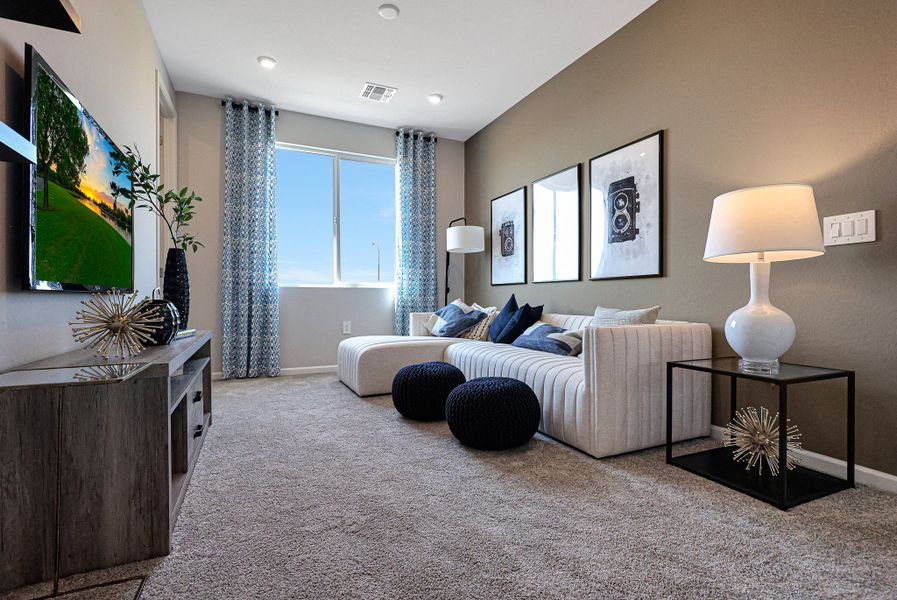 A living room with a tv and couches. A living room with a tv and couches.