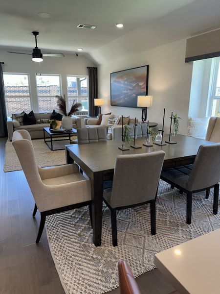 A cozy open-concept living and dining area with elegant decor, neutral tones, and large windows inviting natural light. A cozy open-concept living and dining area with elegant decor, neutral tones, and large windows inviting natural light.