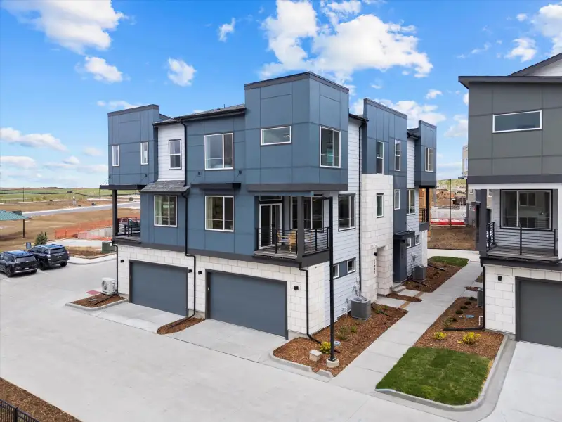 Front exterior of a home in the Lyric at RidgeGate Townhomes community, located in Lone Tree, CO (Image 1).
