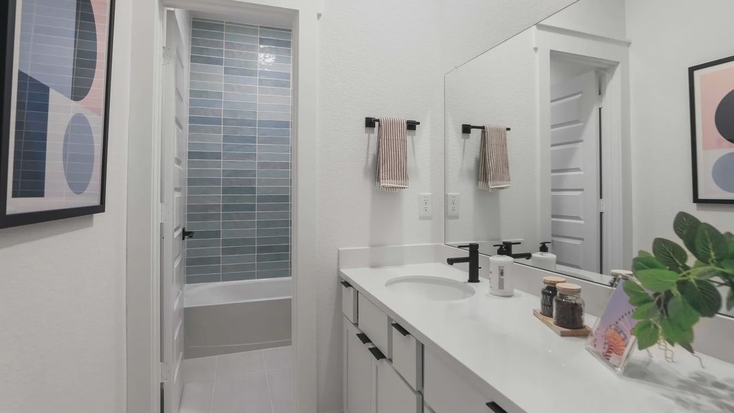 Experience refined elegance with sleek countertops, chic black fixtures, and contemporary art in Mostyn Springs. Experience refined elegance with sleek countertops, chic black fixtures, and contemporary art in Mostyn Springs.