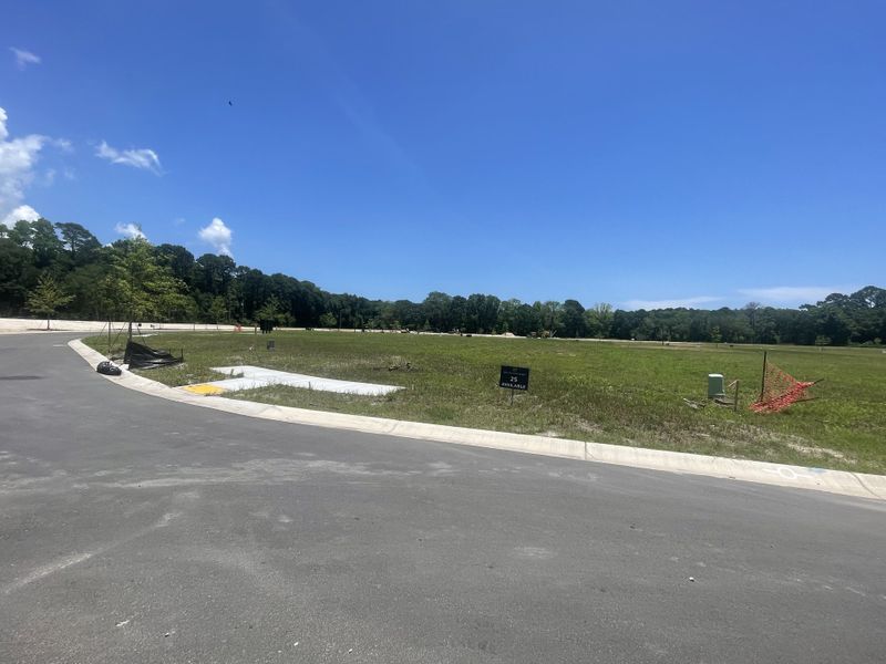 Expansive green lot under clear skies in Miller's Crossing by Dream Finders Homes, Johns Island, SC.