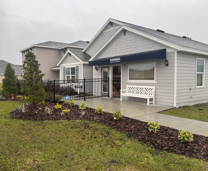 A charming gray home with lush landscaping in Avalon Woods by D.R. Horton (Newberry, FL).