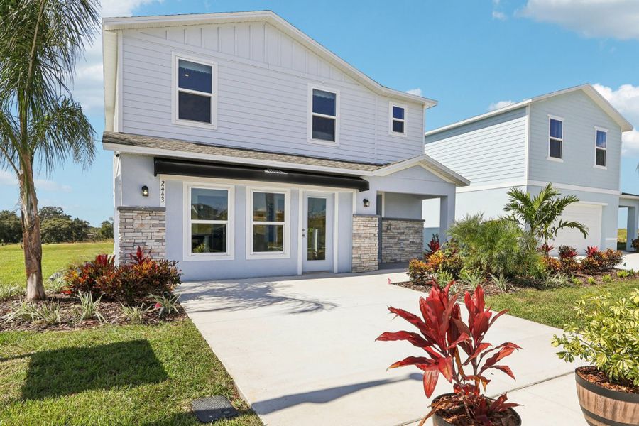 A white house with a driveway.