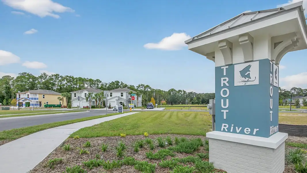 Entrance to the Trout River community in Jacksonville, FL, featuring signage and landscaping (Image 1).
