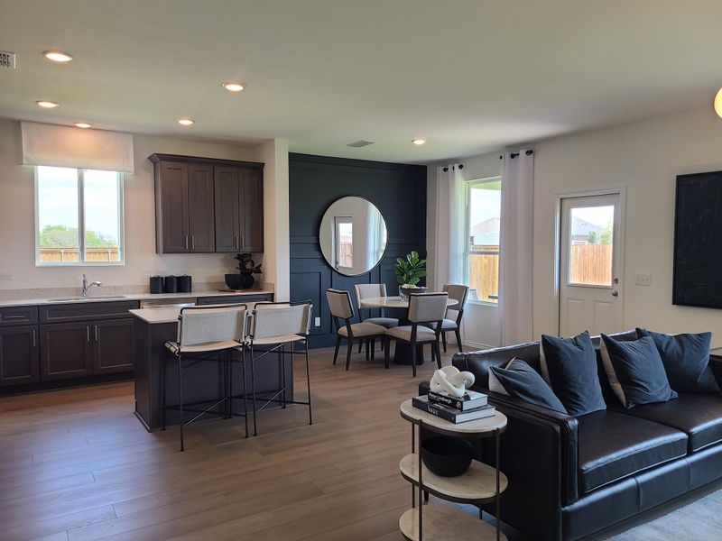 A modern open-plan living area with a sleek kitchen, cozy seating, and elegant dining space, featuring stylish décor. A modern open-plan living area with a sleek kitchen, cozy seating, and elegant dining space, featuring stylish décor.