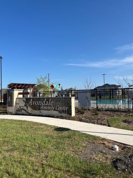 The Avondale Amenity Center features inviting outdoor spaces and a pool in Avondale 45' by Perry Homes (Fate, TX).