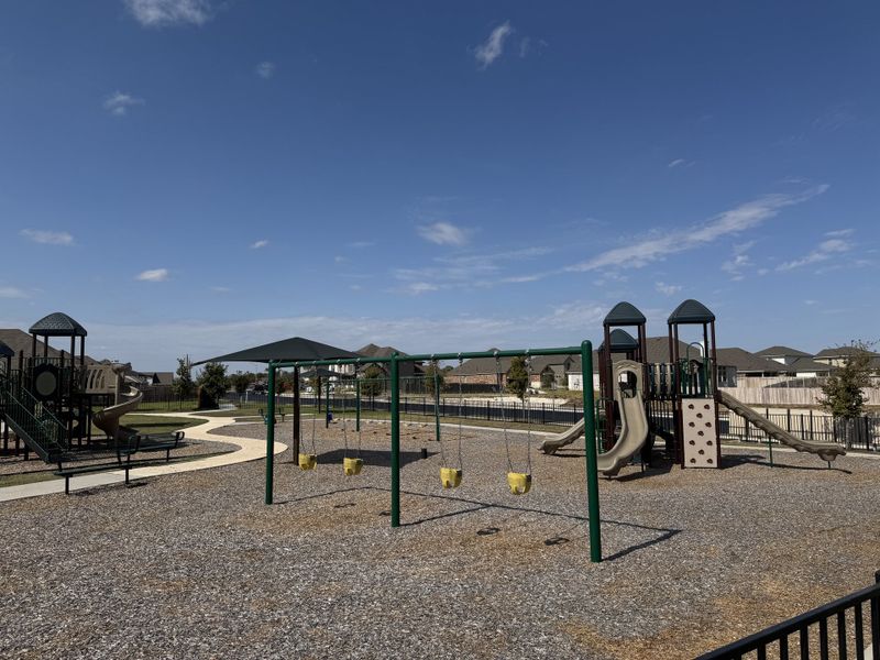 A vibrant playground with slides and swings in Highlands North by Brightland Homes, offering family-friendly amenities (Hutto, TX). A vibrant playground with slides and swings in Highlands North by Brightland Homes, offering family-friendly amenities (Hutto, TX).