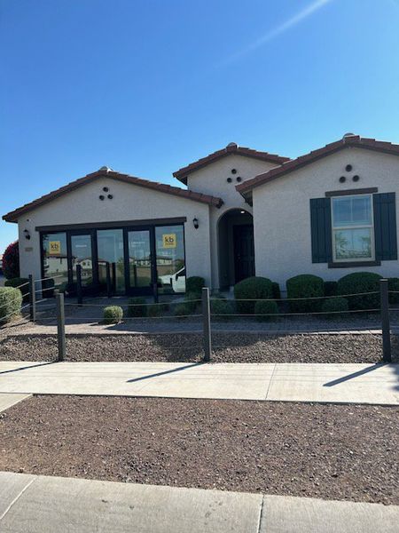 Charming desert-style home with dark shutters and a tile roof in Ventana de Estrellas Enclaves by KB Home (Goodyear, AZ).