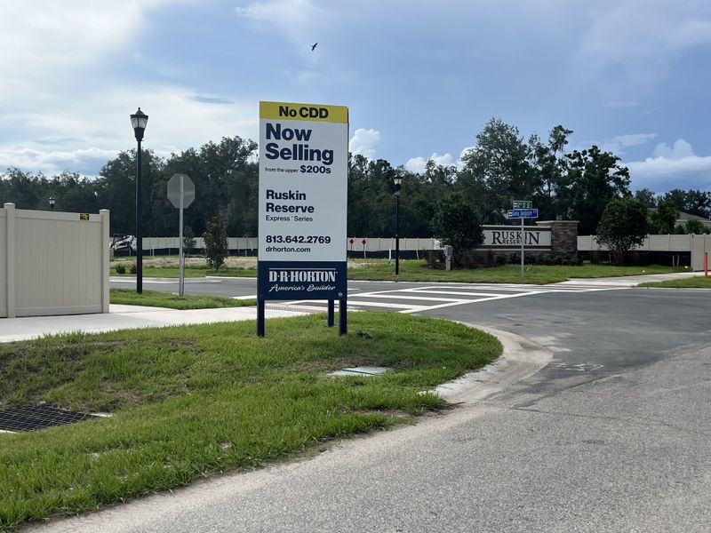 A welcoming entrance to Ruskin Reserve by D.R. Horton in Ruskin, FL, featuring lush greenery and a clear community sign.
